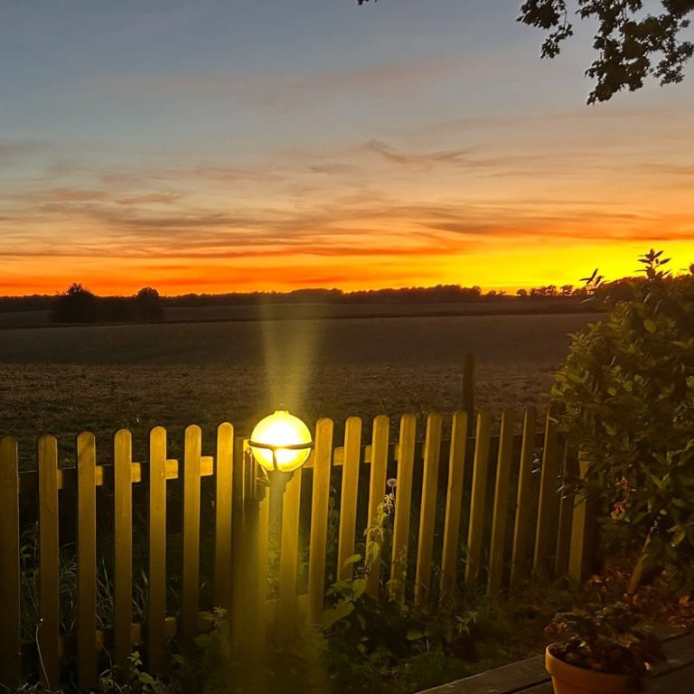 A beautiful view of the sun setting over the fields behind The Stag Pub and Kitchen in Flackwell Heath.