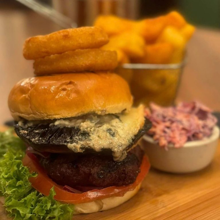 Our delicious signature Stag Burger, with three times cooked chips, onion rings and purple coleslaw at The Stag Pub and Kitchen in Flackwell Heath. 